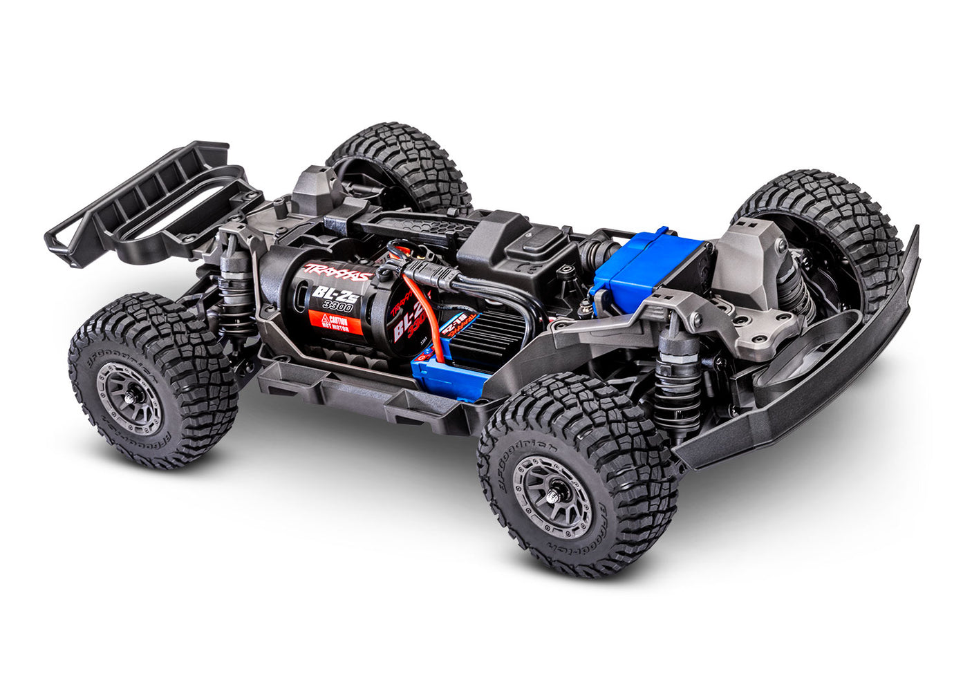 Traxxas Mini Slash 4X4 RC truck showing detailed chassis and off-road tires on a rugged terrain.