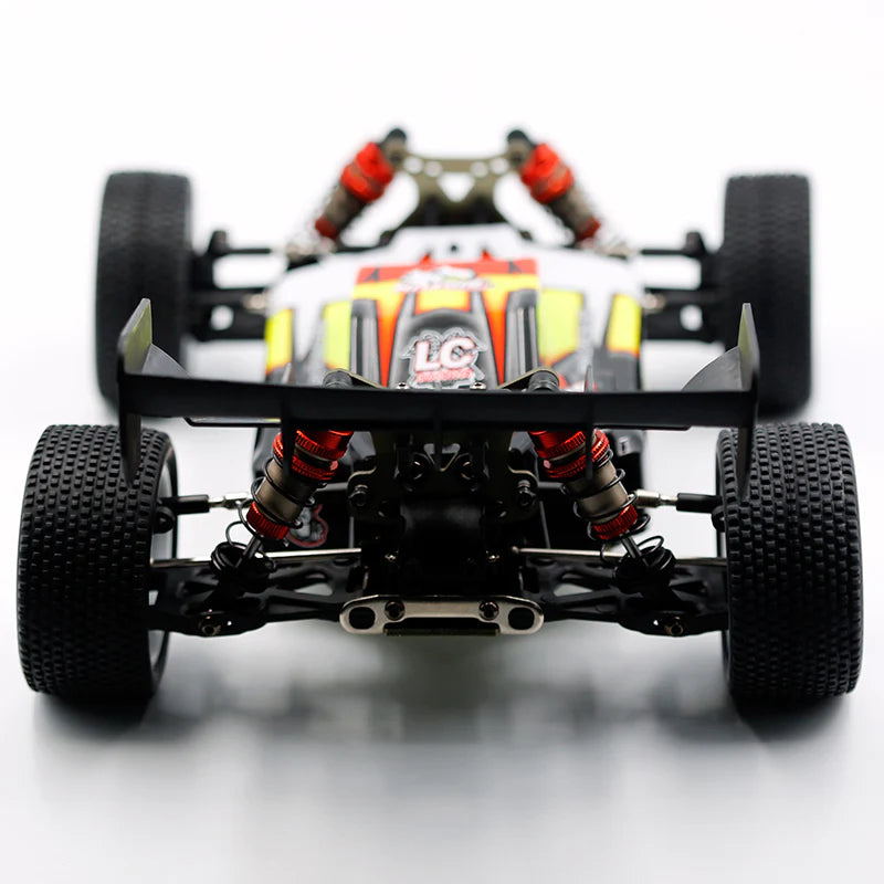 LC Racing EMB-1 1/14 scale 4WD RTR buggy, detailed close-up showing the chassis and off-road tires.