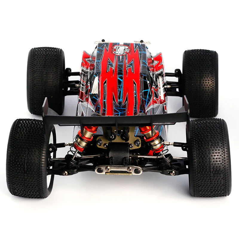 LC Racing EMB-T 1/14 scale 4WD RTR Truggy RC car with detailed body and off-road tires on a racing track.