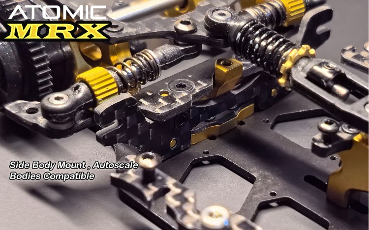 Atomic RC MRX 2WD Pan Car Kit showing sleek black chassis and detailed components on a racing track.