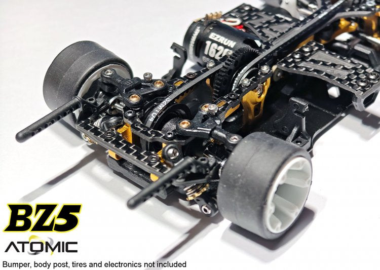 Atomic RC Z5 Belt Drive 4WD RC chassis kit with durable components and sleek design, shown with assembled frame and drivetrain parts.