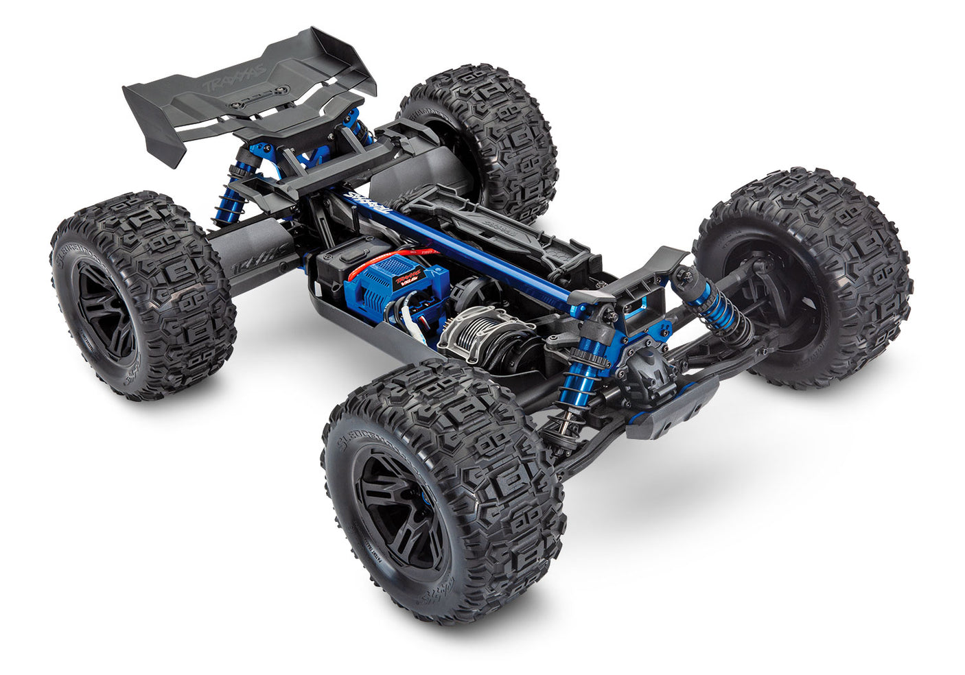 Traxxas 1/8 Sledge belted chassis showing front and side view with detailed suspension and rugged off-road tires.