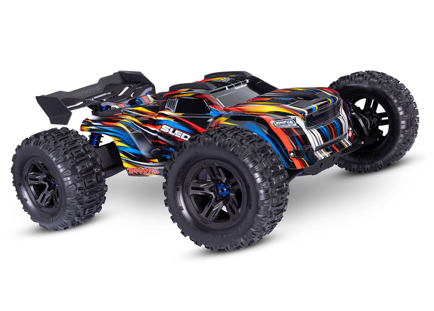 Traxxas 1/8 Sledge belted RC truck with blue body and detailed front view, showcasing rugged design and large tires.
