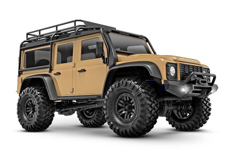 Traxxas TRX-4M Land Rover Defender remote control scale model vehicle, tan color, front three-quarter view.