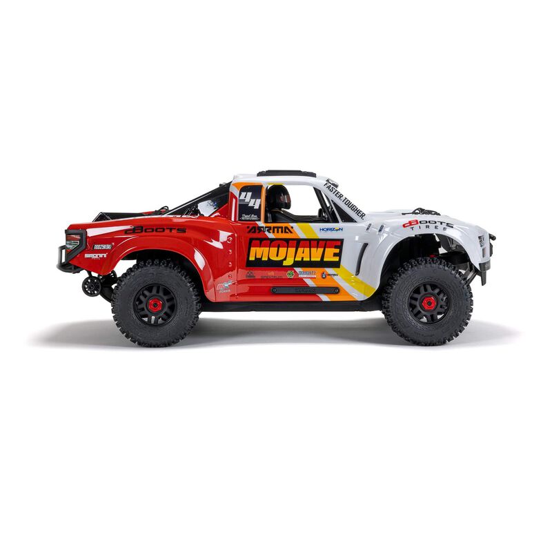ARRMA 1/8 Mojave 4S 4x4 RTR desert truck with off-road tires and detailed body in an outdoor setting