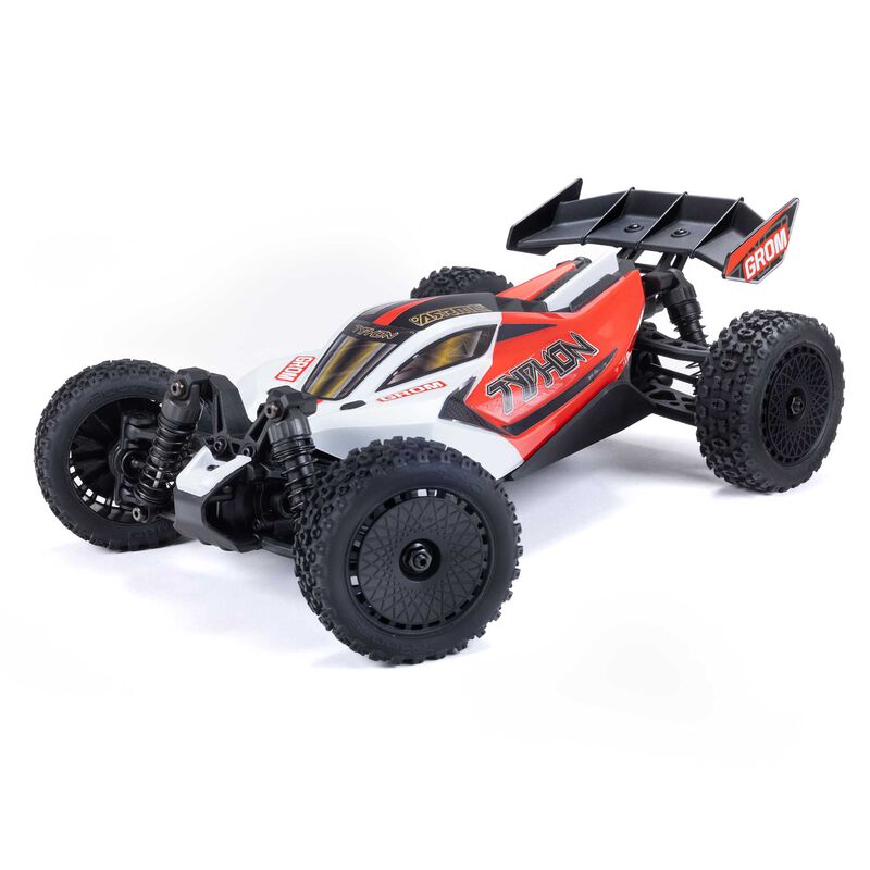 ARRMA 1/14 Typhon GROM 4X4 RTR brushed buggy on rugged terrain, showcasing its off-road design and vibrant orange body.