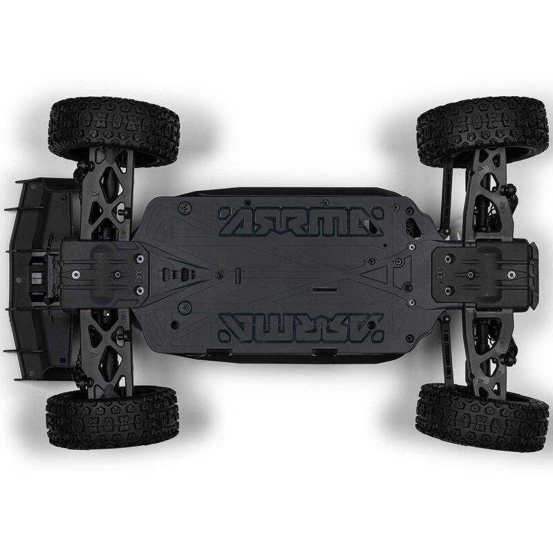 ARRMA 1/8 scale Typhon 4x4 RTR brushed buggy shown on a dirt track with vibrant orange and black body and large off-road tires.