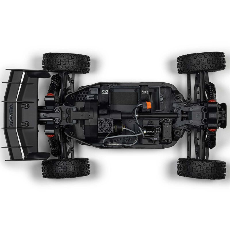 ARRMA 1/8 scale Typhon 4x4 RTR brushed buggy on rugged terrain with detailed body and large off-road tires.