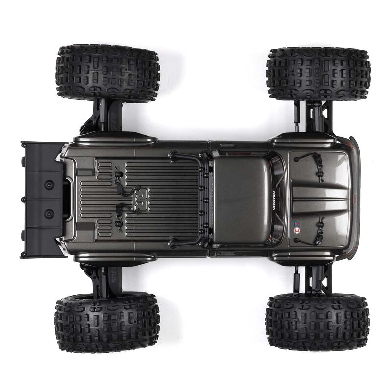 ARRMA Outcast 4X4 4S 1/10th scale 4WD stunt truck shown on rugged terrain, featuring bold design and off-road tires.