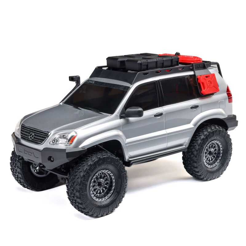 Axial 1/24 SCX24 Lexus GX 470 4X4 RTR brushed rock crawler on rugged terrain with detailed exterior and off-road features.