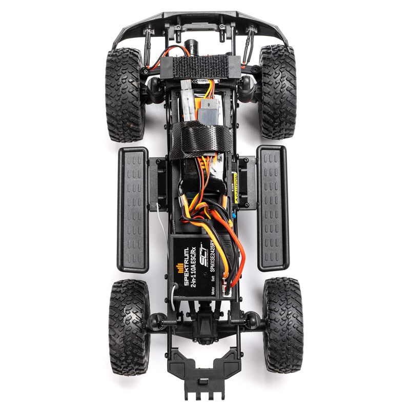 Axial 1/24 SCX24 Lexus GX 470 4X4 RTR brushed rock crawler on rugged terrain with detailed exterior and off-road features.