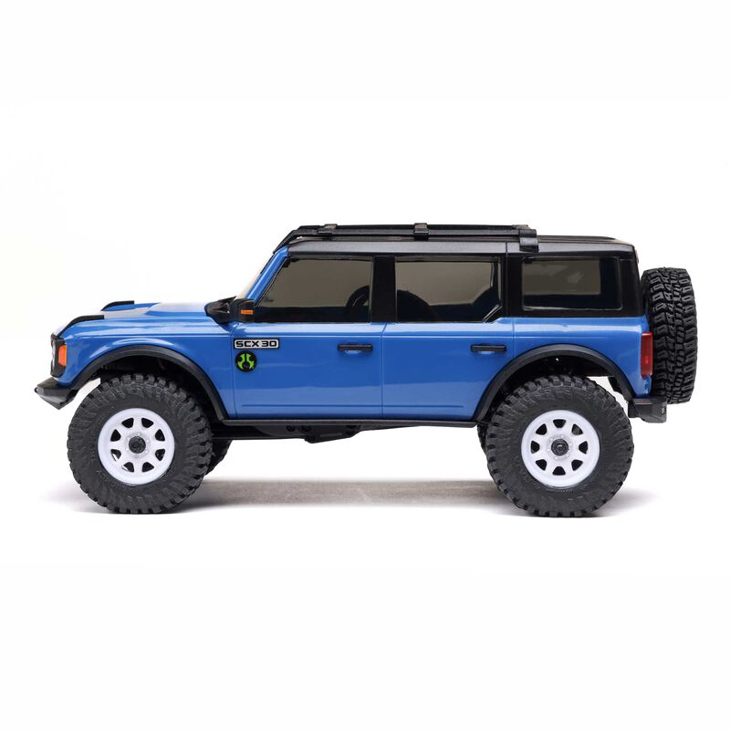 Axial 1/30 scale SCX30 Ford Bronco 4x4 RTR brushed rock crawler on rugged terrain.