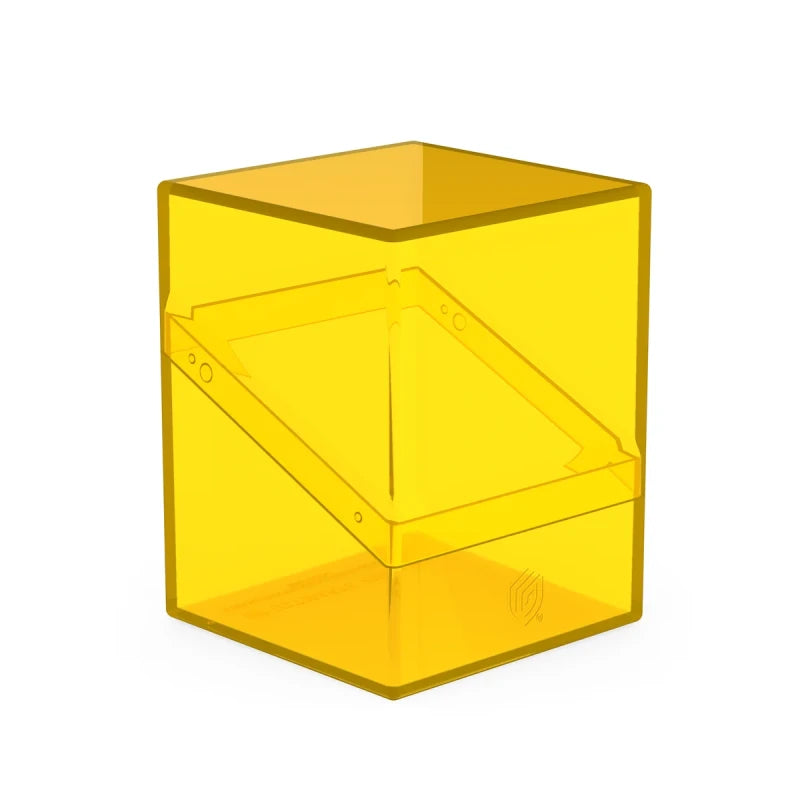 Clear amber Ultimate Guard Boulder 100+ deck case for card storage, featuring durable plastic construction and secure lid.