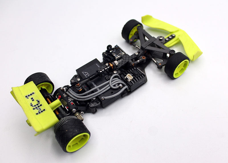 Red Reflex Racing FX28 Formula RC car kit with detailed body and racing decals on a smooth track surface.