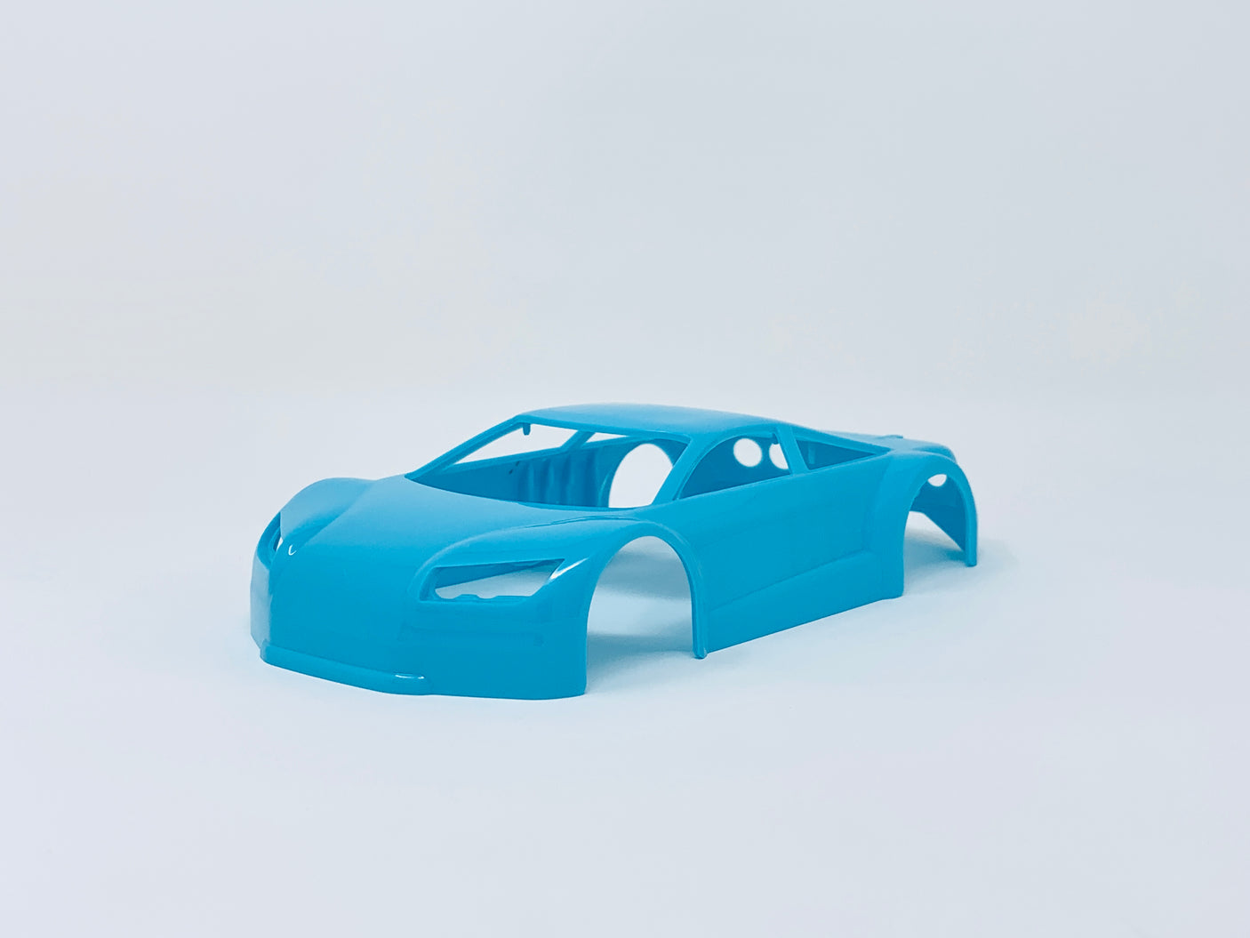 Neon blue Jomurema GT01 car body set on a white background, showcasing detailed design and vibrant color for the Jomurema brand.