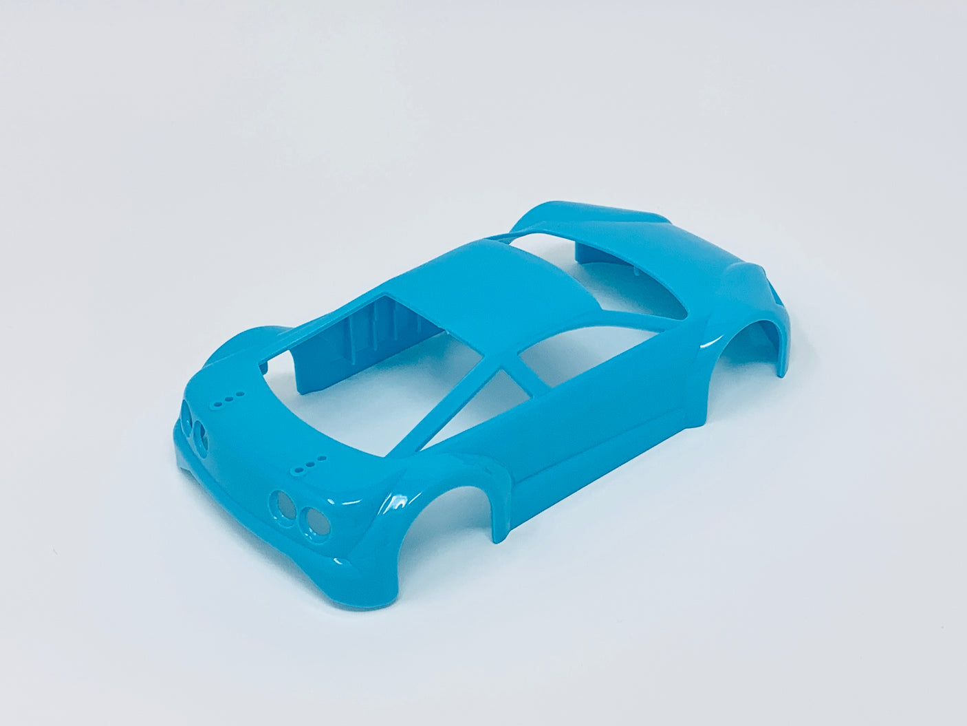 Jomurema GT01 car body set in vibrant neon blue with sleek aerodynamic design, shown on a plain background.