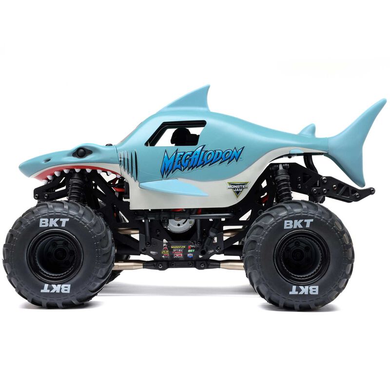 Losi 1/18 Mini LMT Megalodon 4x4 brushed monster truck on rugged terrain, showcasing its compact off-road design and detailed body.