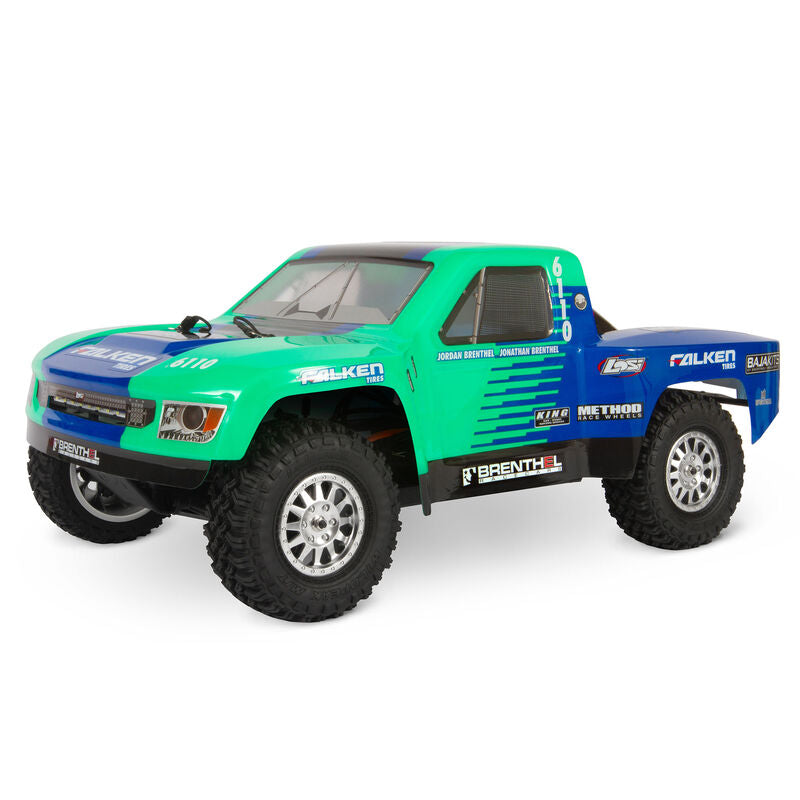 Losi 1/10 Tenacity TT Pro Falken 3S 4WD RTR brushless desert truck on rugged terrain, showcasing its off-road design and vibrant decals.