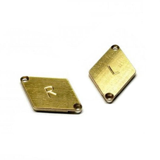 Atomic RC MRZ brass 1.5g weight for V2 chassis, shown attached to the chassis in a close-up view.