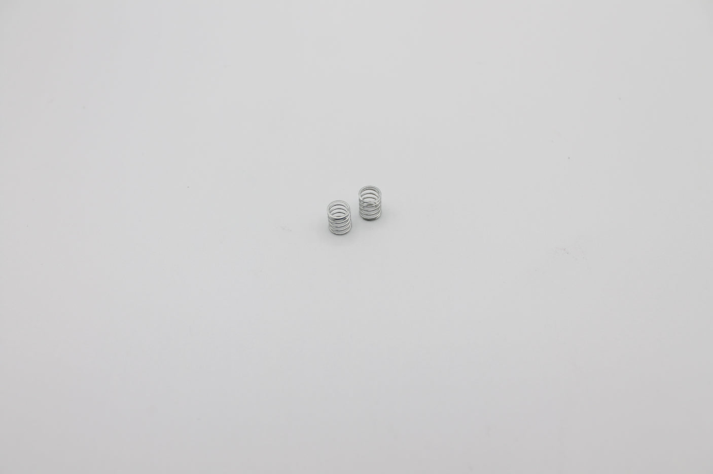 Reflex Racing RX28A-09 soft front springs for RC car, white silver color, shown in close-up image.