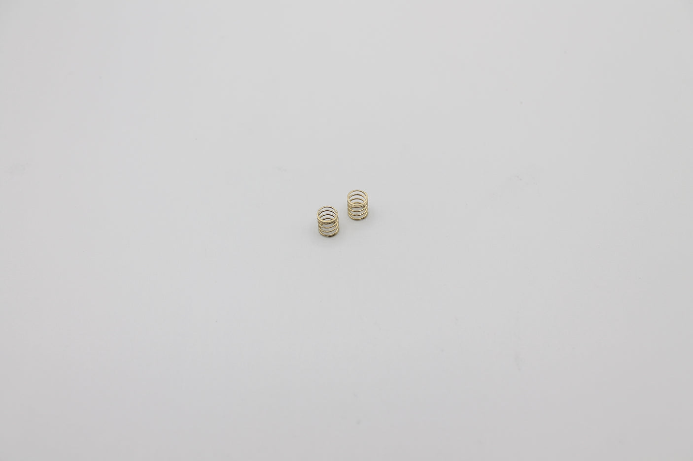 Reflex Racing RX28A-12 gold hard front springs for RC car suspension, designed for performance and durability.