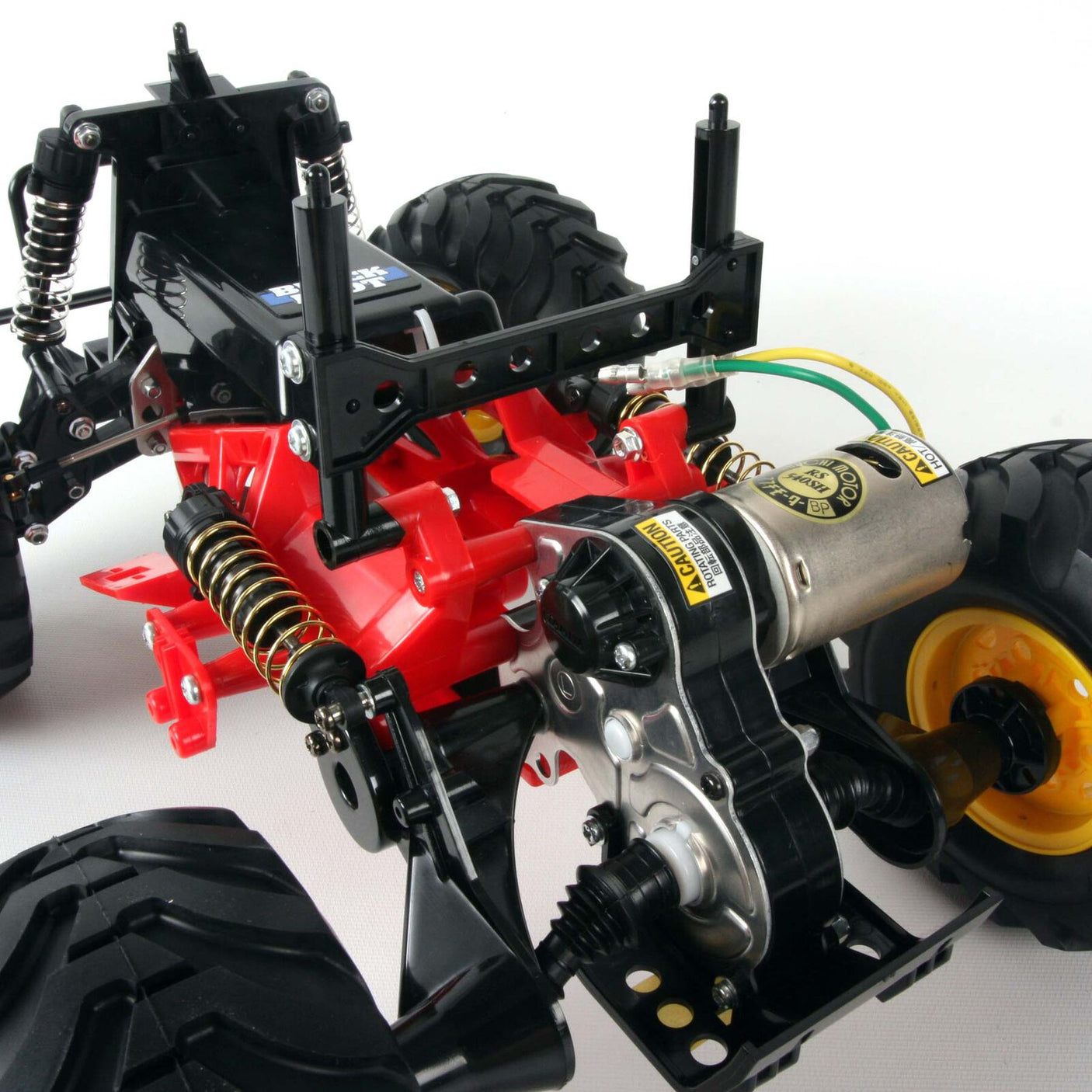 Tamiya 1/10 Blackfoot 2WD Monster Truck Kit model with detailed orange and black body and rugged off-road tires.