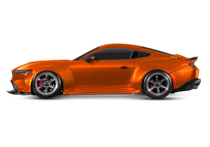 Red Traxxas 4-Tec Drift Ford Mustang RC car on a track, showcasing detailed body design and drifting tires.