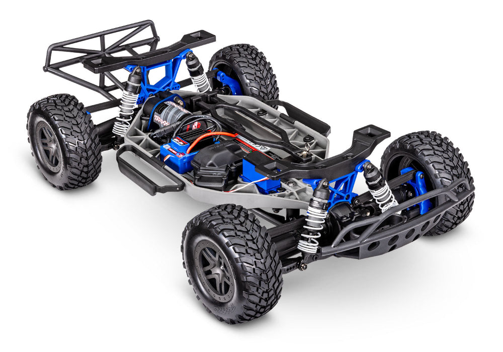 Traxxas Slash 4X4 BL-2s remote control off-road truck with rugged tires and detailed body in a natural outdoor setting