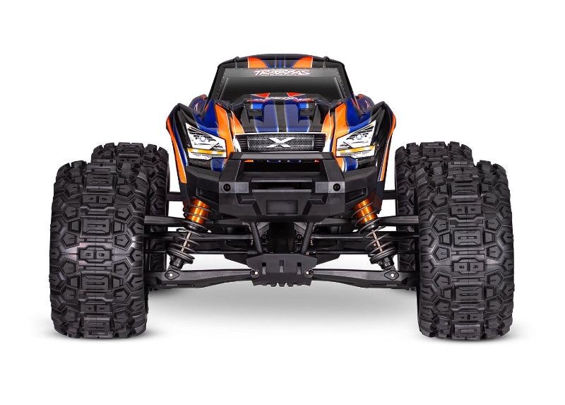Bright yellow Traxxas X-Maxx 8s RC monster truck with large tires and detailed suspension in a dynamic outdoor setting.