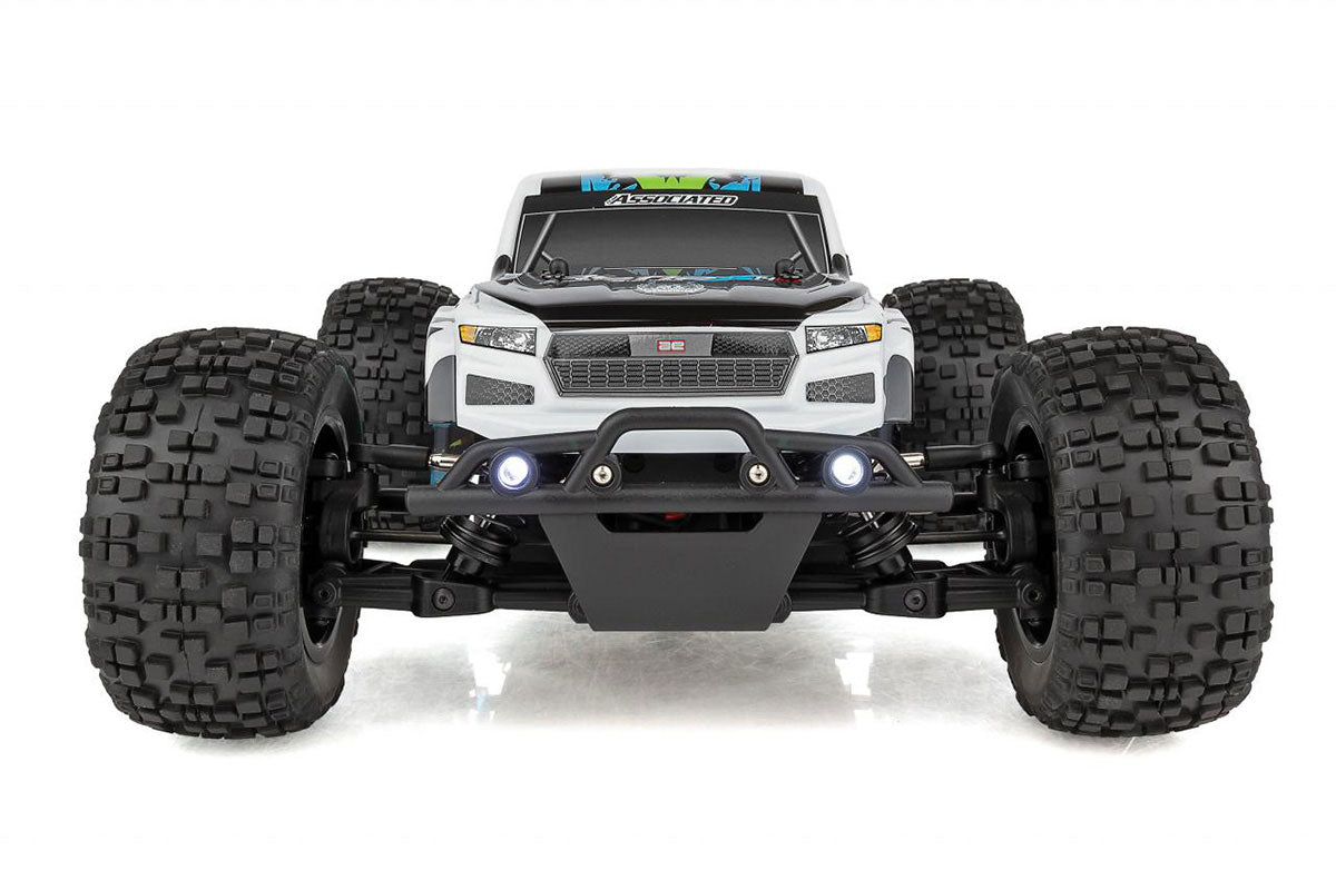 Team Associated Reflex 14MT 1/14 scale 4WD RC monster truck with detailed body and rugged tires on rugged terrain.