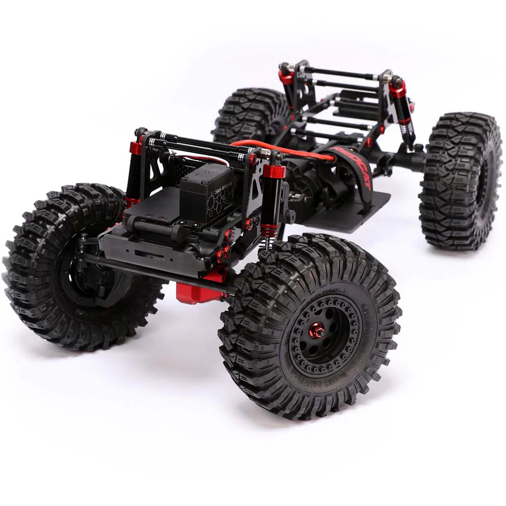 Redcat Ascent Fusion 1/10 scale brushless RTR rock crawler with st chassis and rugged tires on rough terrain.