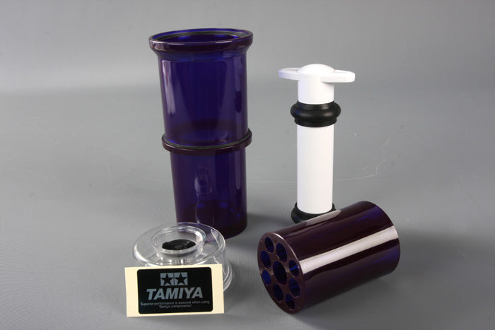 Tamiya Super Long Damper Oil Air Remover for RC cars, shown in a clear container with orange liquid inside.