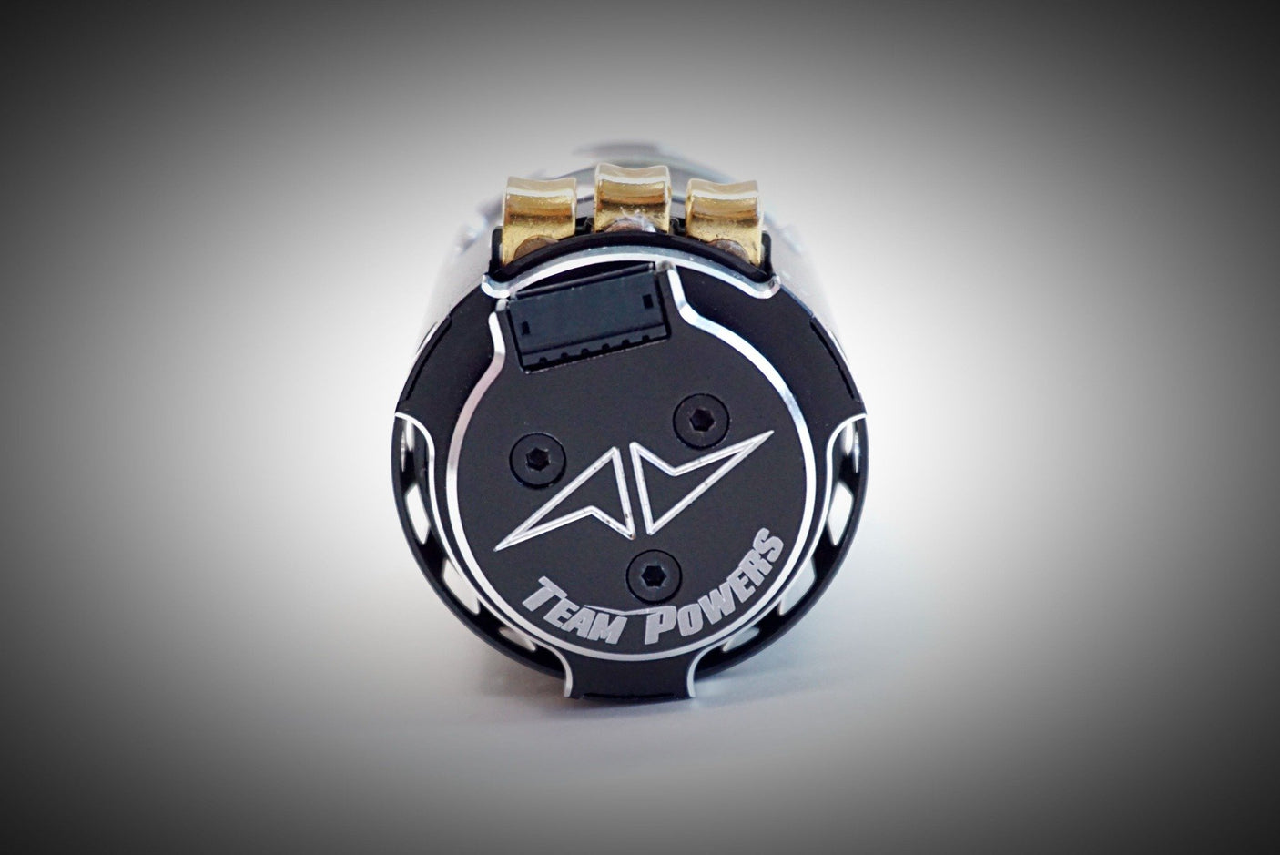 Team Powers Actinium V5 brushless RC car motor shown from the back, highlighting its design and cooling features.