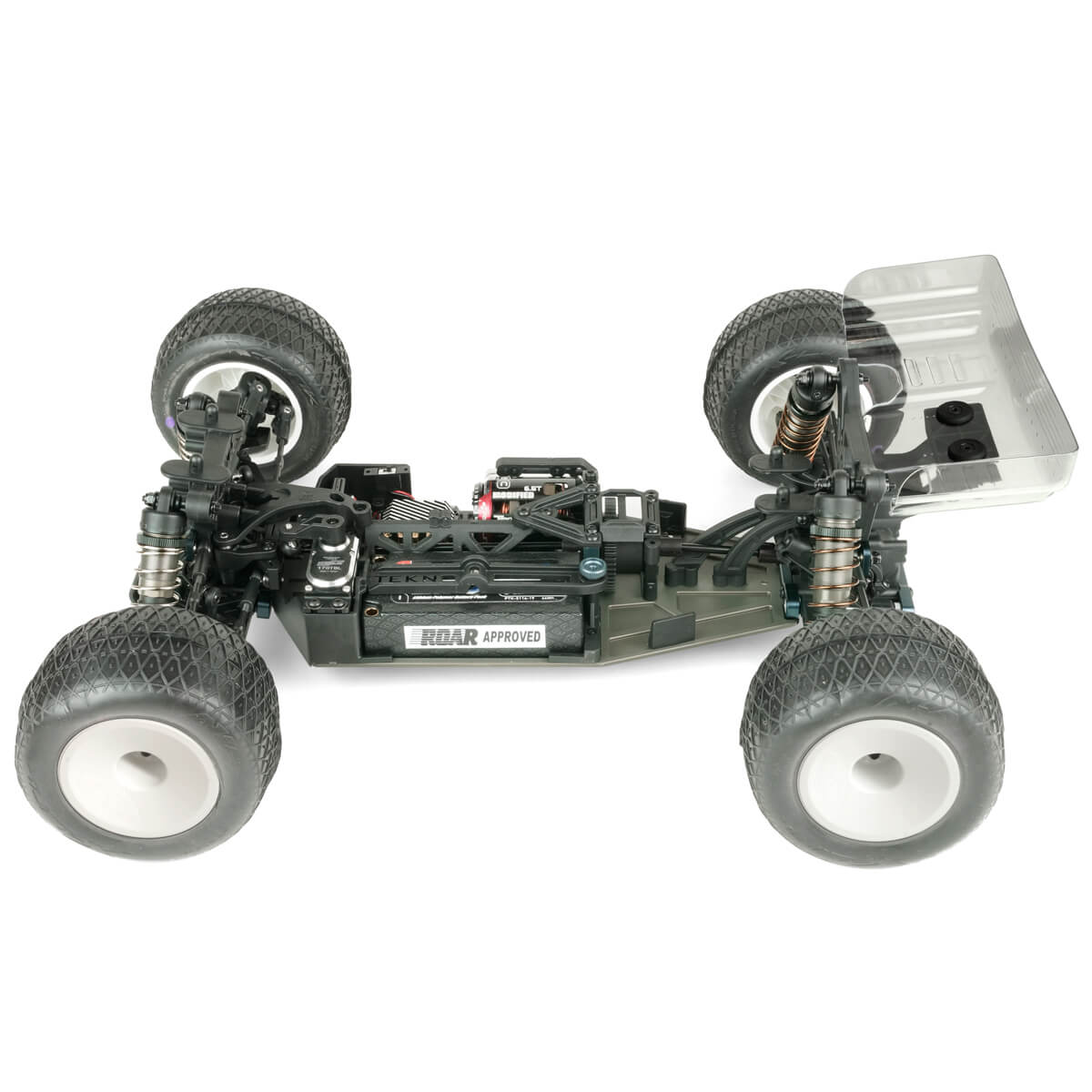 Tekno TKR7202 ET410.2 1/10th scale 4WD electric RC truggy kit on a track, showcasing its detailed chassis and rugged tires.