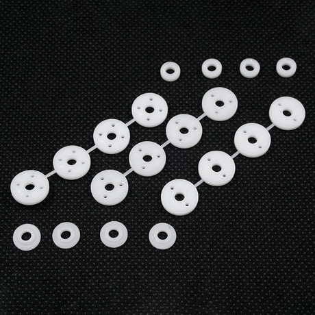 Xpress Composite 1.1mm Hole Piston and Spacer Set showing metallic pistons and spacers with detailed components.