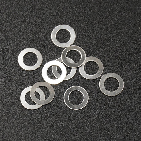 Set of ten Xpress steel spacers, 3x5x0.2mm, small metal components for electronics or DIY projects.