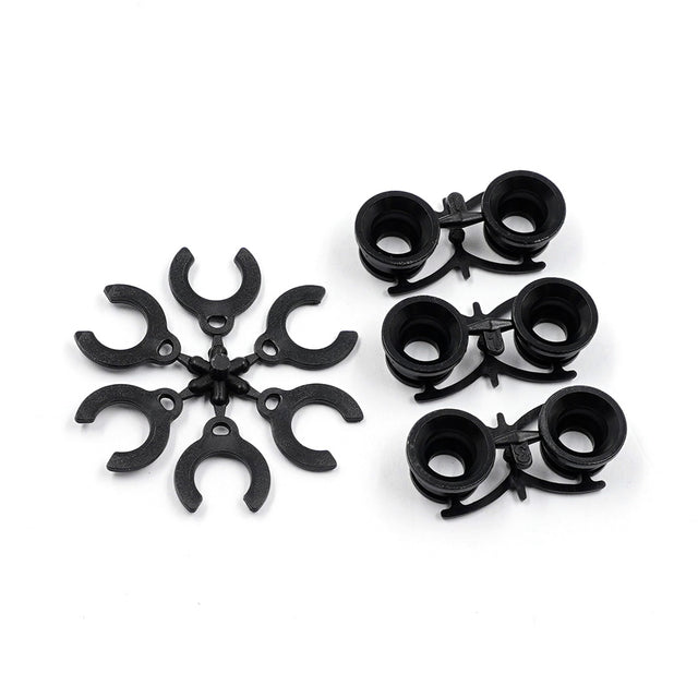 Xpress Pivot Inserts for Graphite Lower Arm, close-up view showing precision-machined metal components for RC car upgrades.