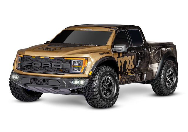 Traxxas Ford Raptor R 4X4 Ultimate remote control truck with gold accents, showing a three-quarter front view.