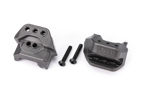 Pair of Traxxas lower shock mounts for RC car suspension, shown in black with mounting holes visible.