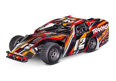 Traxxas Slash Modified BL-2s RC truck with orange body and detailed front view, showcasing its off-road design and vibrant color.