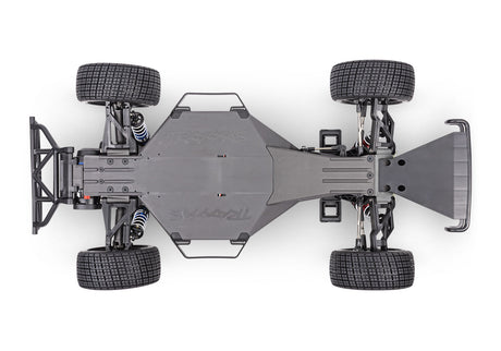 Traxxas Slash Late Model BL-2s RC car chassis viewed from the bottom showing detailed components and construction.