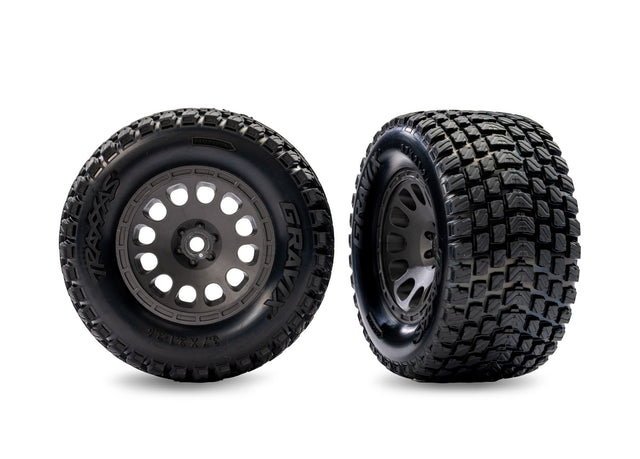 Pair of gray Traxxas Gravix pre-mounted front wheels for Mini XRT RC truck, showing detailed tire treads and wheel rims.
