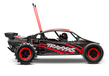 Red Traxxas Pro Scale Sand Car shown from the right side, featuring detailed design and off-road racing features.