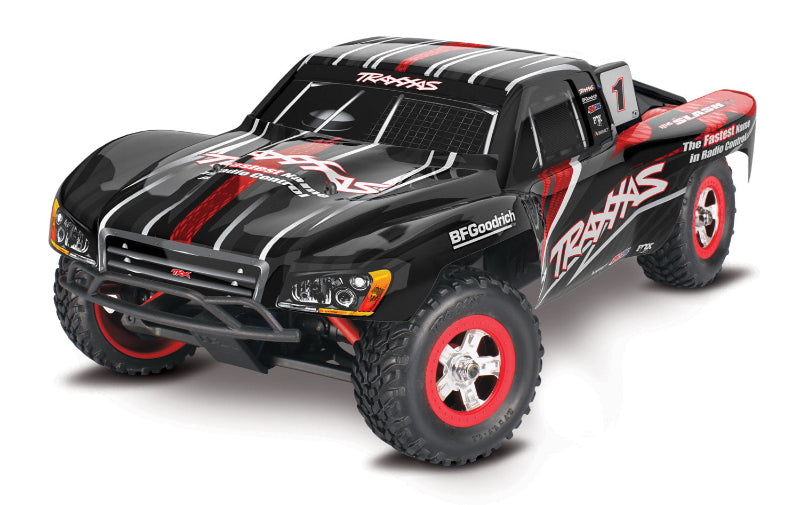 Traxxas 1/16 Slash 4X4 RC truck with detailed body and off-road tires, shown on a dirt track.