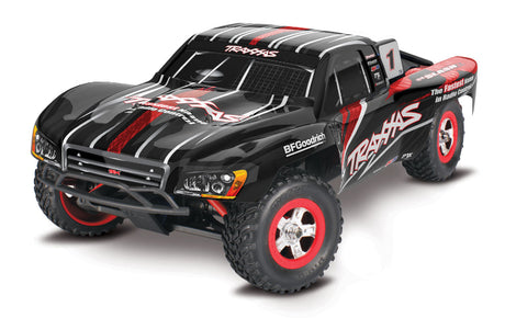 Traxxas 1/16 Slash 4X4 RC truck with detailed body and off-road tires, shown on a dirt track.