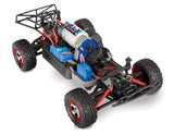 Traxxas 1/16 Slash 4X4 remote control truck with detailed body and off-road tires, shown from side angle.