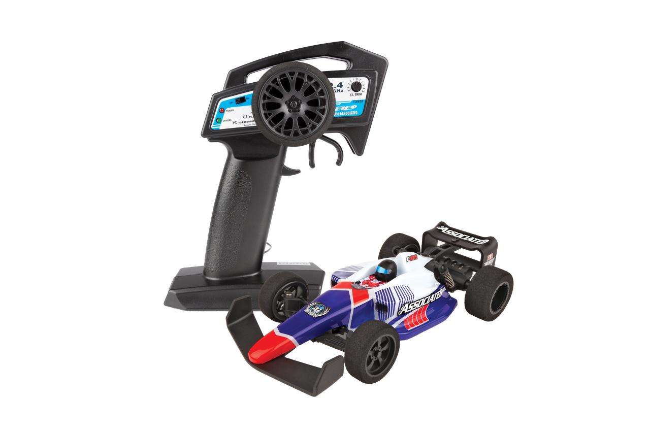 Team Associated F28 Formula RC 1/28 scale 2WD remote control car, showing the detailed orange and black body with racing decals.