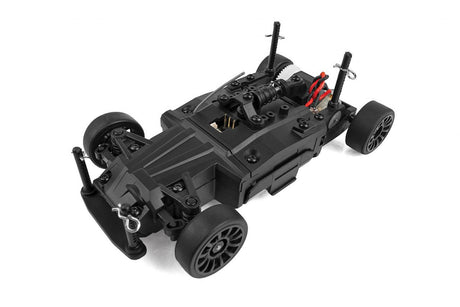 Team Associated SR27 Nissan Z RC car, detailed scale model with vibrant orange body and racing decals, on a smooth surface.