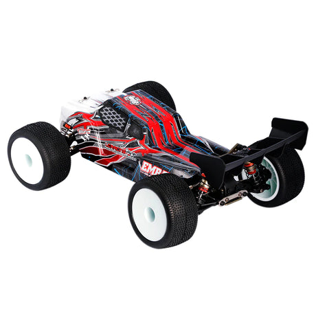 LC Racing EMB-T 1/14 scale 4WD RTR Truggy RC car on a track, showing its detailed body and off-road tires.