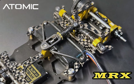 Atomic RC MRX 2WD Pan Car Kit assembled with detailed chassis, tires, and suspension components for remote control racing.